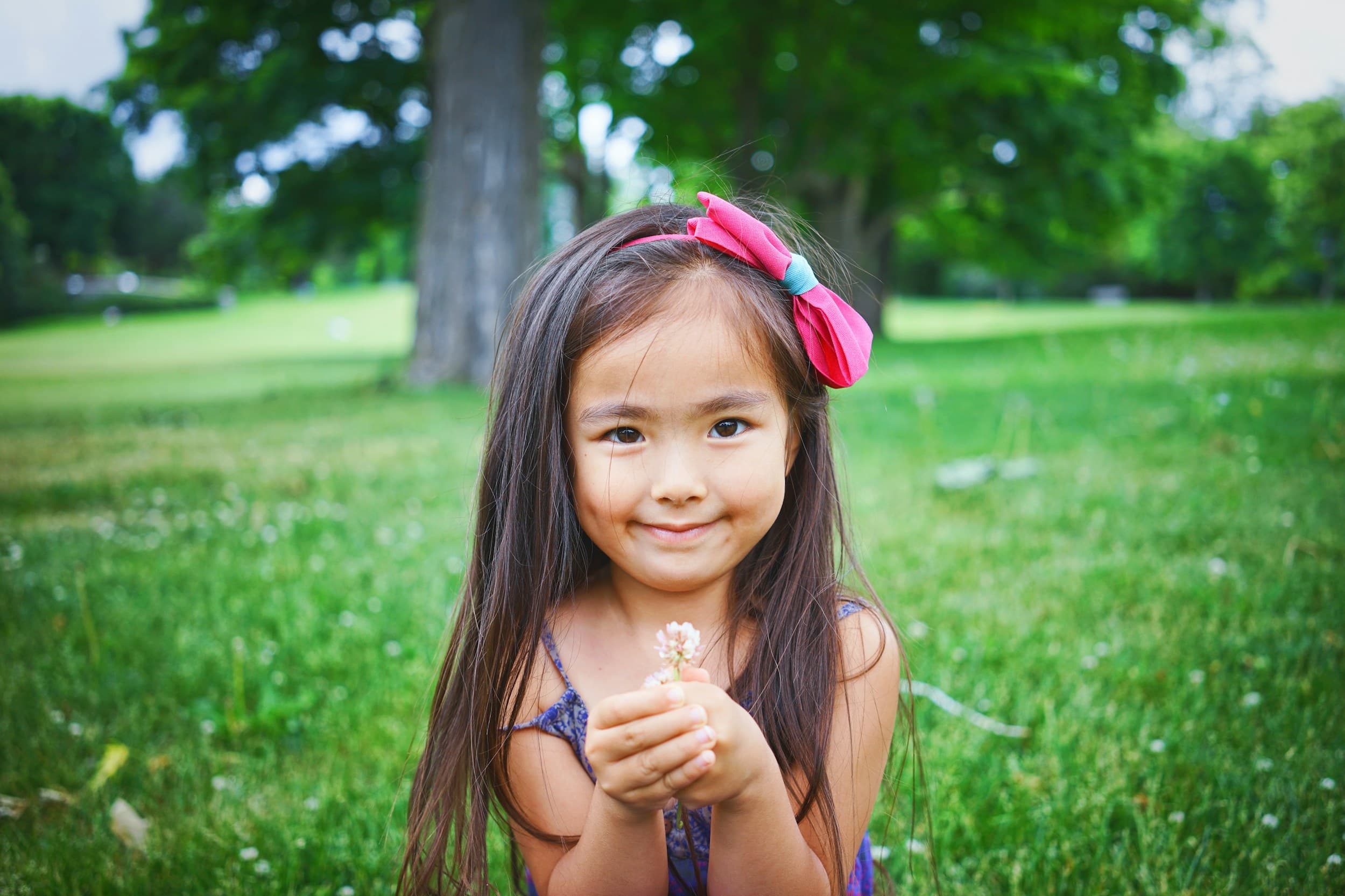 Happy child with pink bow